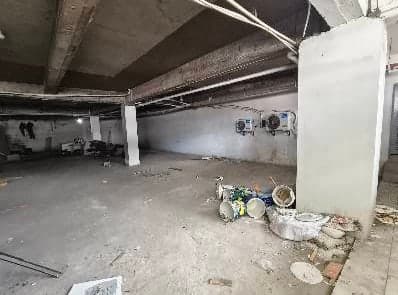 Available commercial unit as bare shell, structural columns and exposed soffit, condenser units mounted along the rear wall