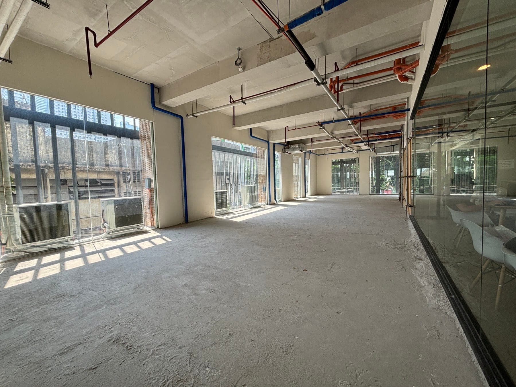 Corner of the unit with windows on two sides and external condenser units beyond