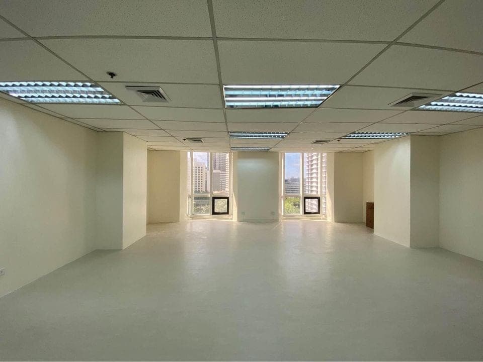 Open fitted floor area running back from the windows, ceiling grid and air conditioning diffusers overhead